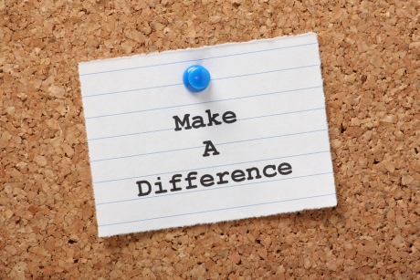 The phrase Make A Difference on a paper note pinned to a cork notice board.